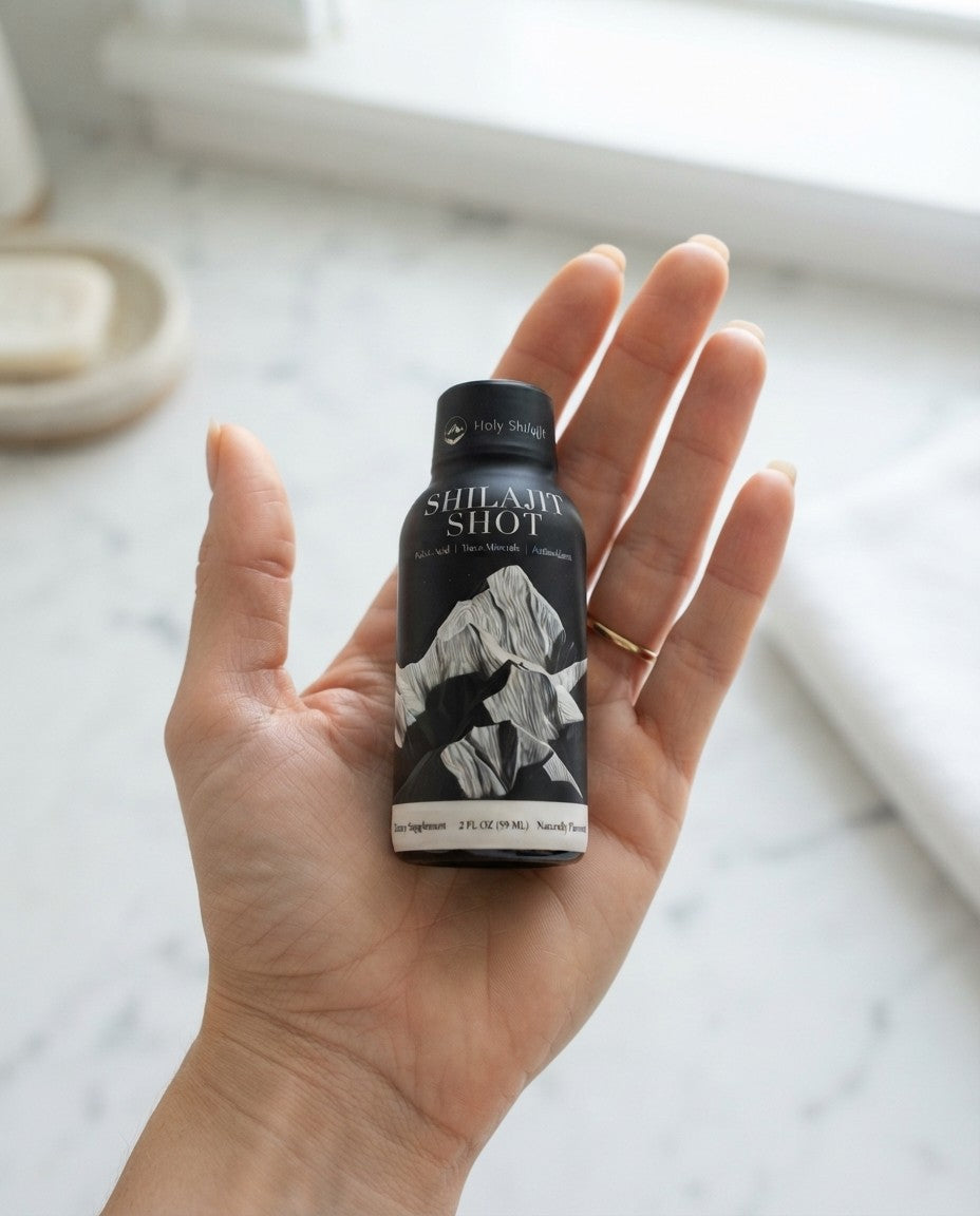 A Holy Shilajit Shilajit Shot standing in the palm of a woman's hand