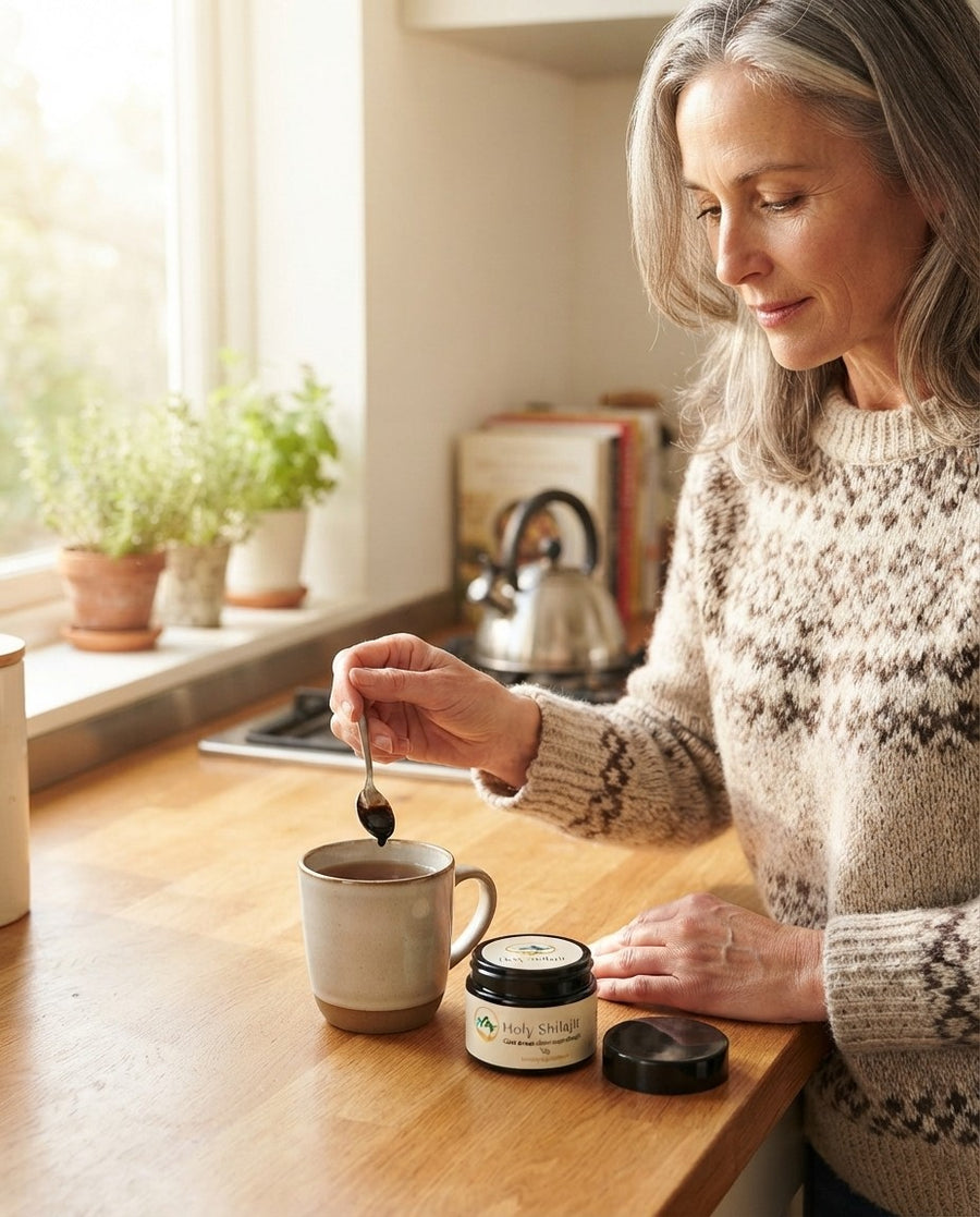 Woman stirring a pea-sized piece of Holy Shilajit resin into her morning tea